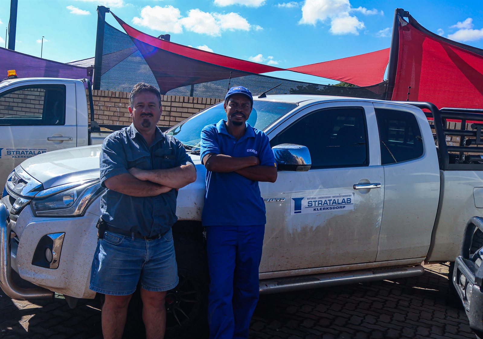 Stratalab staff in front of a branded pickup truck