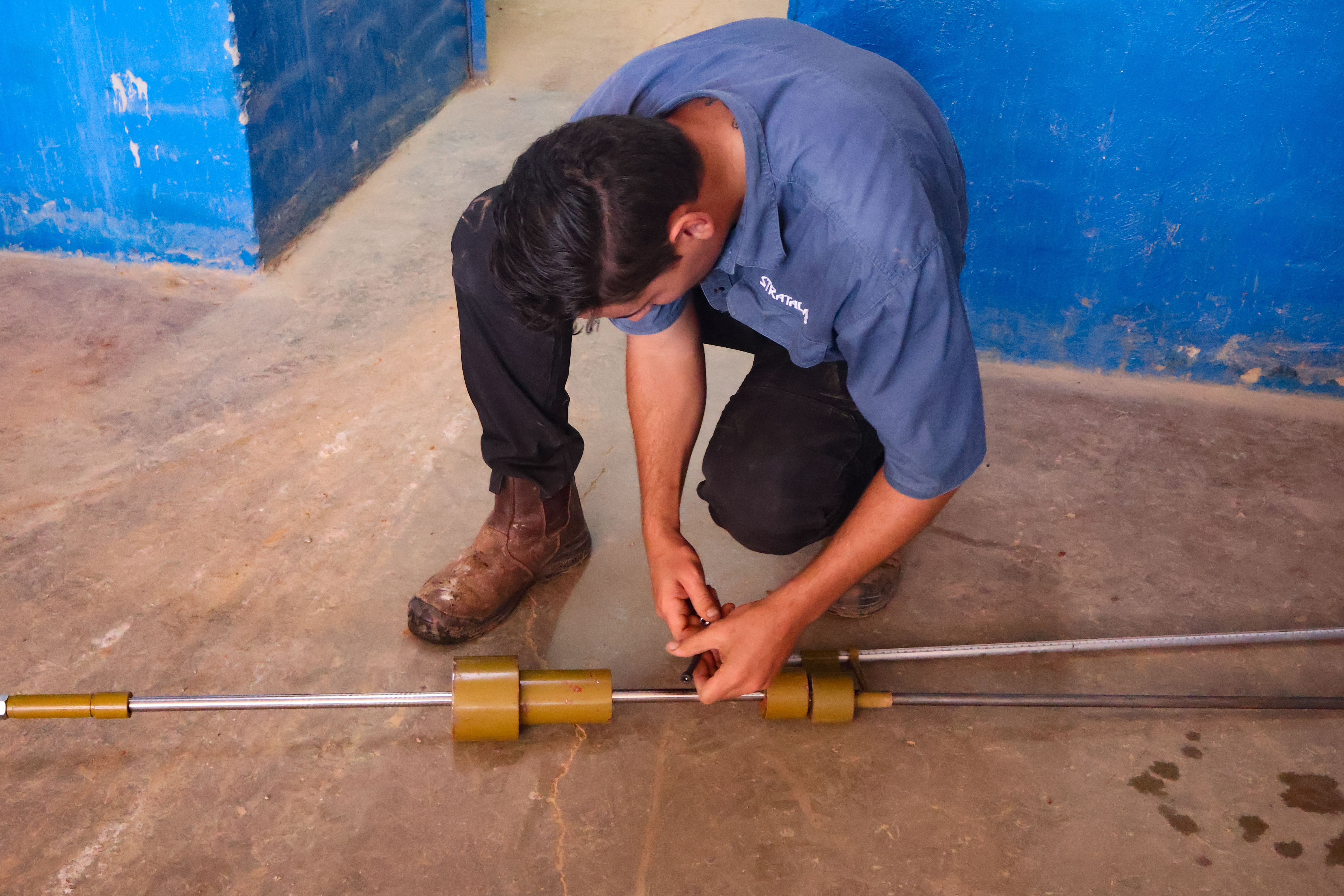 Technician preparing aggregate laboratory testing equipment