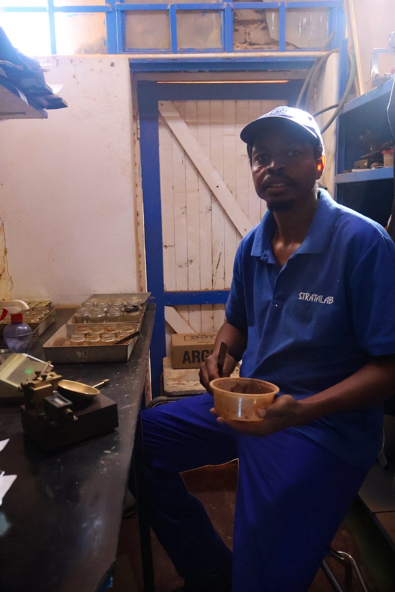 Technician preparing soil material at the laboratory bench